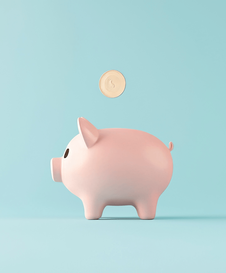 Pink piggy bank with a coin resting on it, set against a vibrant blue background.